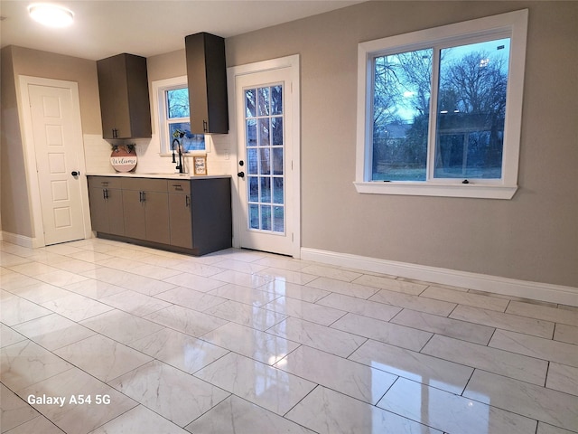 kitchen featuring decorative backsplash and sink