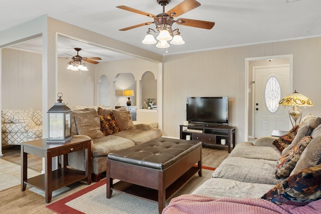 living room with ceiling fan, crown molding, a healthy amount of sunlight, and light wood-type flooring