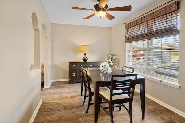 dining area with ceiling fan and wood-type flooring