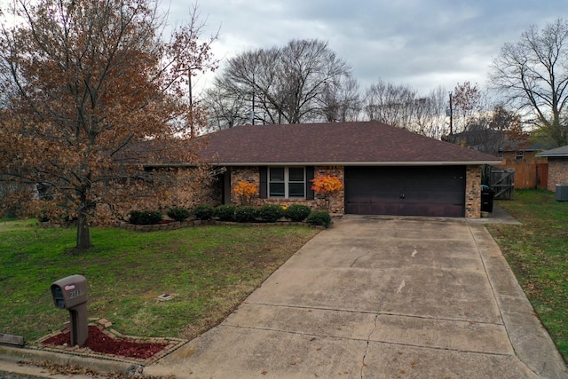 ranch-style house with central AC unit, a garage, and a front lawn