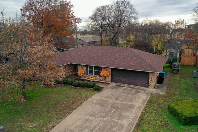 ranch-style home with a front yard and a garage