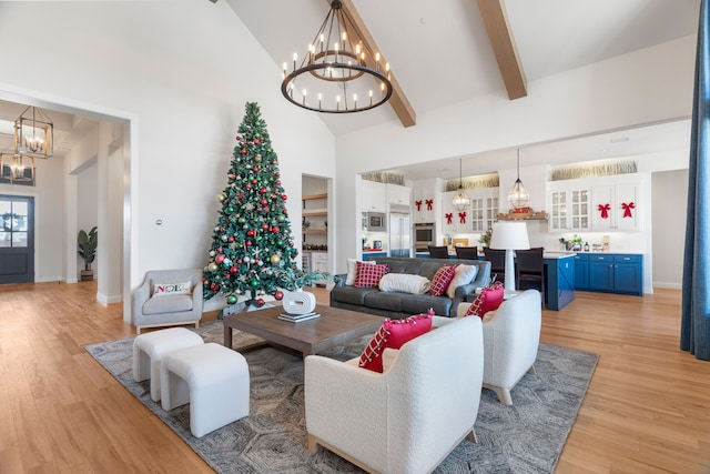 living room with beamed ceiling, light hardwood / wood-style flooring, high vaulted ceiling, and a chandelier