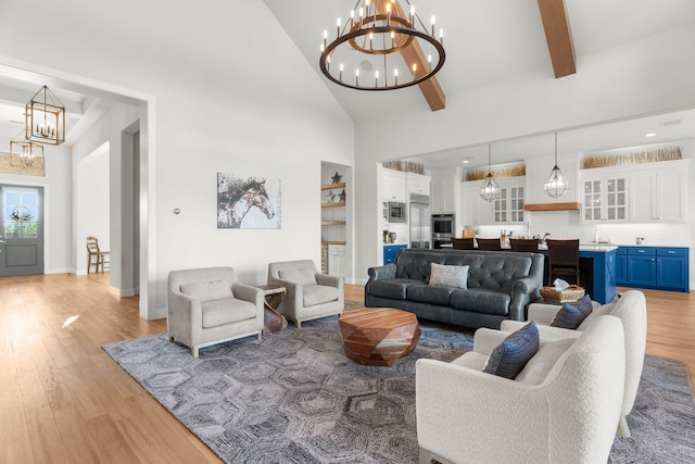 living room featuring beam ceiling, sink, high vaulted ceiling, a notable chandelier, and light wood-type flooring