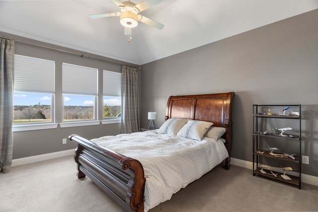 carpeted bedroom with ceiling fan and lofted ceiling