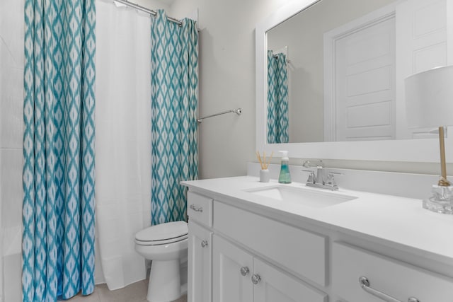 bathroom featuring tile patterned flooring, vanity, toilet, and a shower with shower curtain