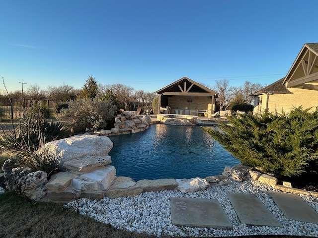 view of pool featuring an in ground hot tub