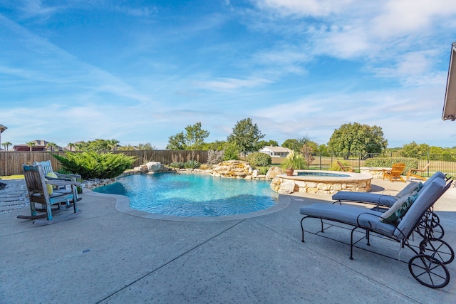 view of pool featuring an in ground hot tub, pool water feature, and a patio