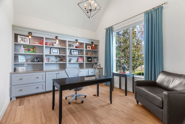 home office featuring high vaulted ceiling, light wood-type flooring, a wealth of natural light, and a chandelier