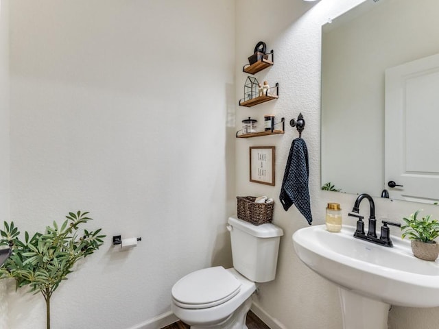 bathroom featuring sink and toilet