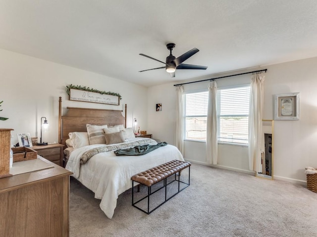 bedroom featuring light carpet and ceiling fan