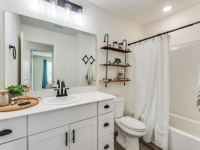 full bathroom with shower / bath combination with curtain, vanity, and toilet