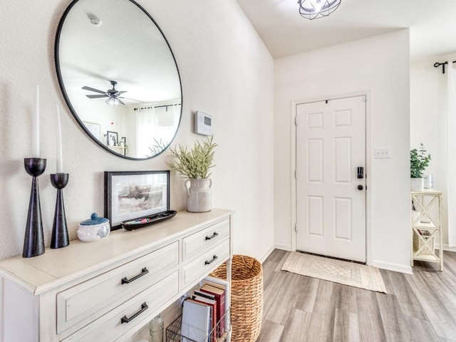 foyer entrance featuring light wood-type flooring and ceiling fan