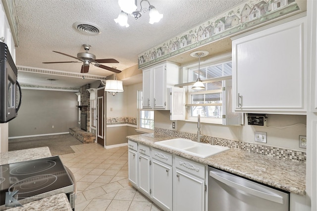 kitchen with range, white cabinetry, stainless steel dishwasher, and sink