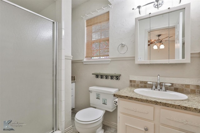 bathroom featuring decorative backsplash, vanity, an enclosed shower, and toilet