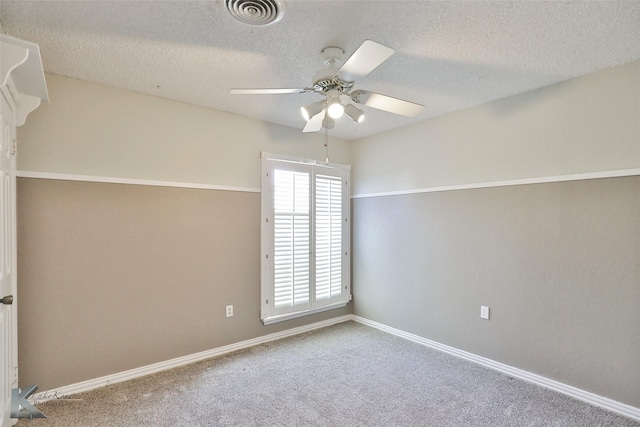 carpeted spare room featuring a textured ceiling and ceiling fan