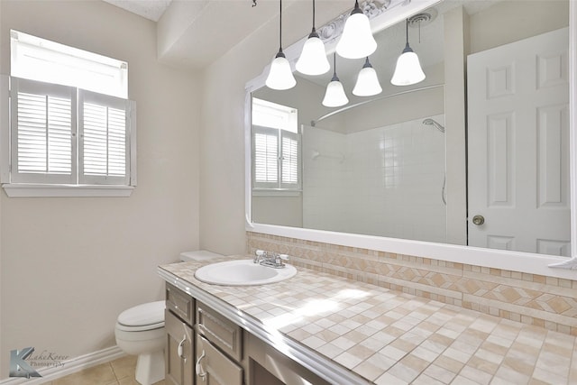 bathroom with vanity, a shower, backsplash, tile patterned flooring, and toilet