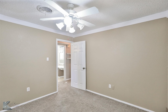 unfurnished room with a textured ceiling, ceiling fan, and light carpet