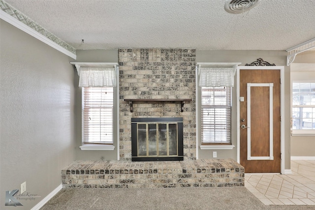 unfurnished living room with a fireplace, a textured ceiling, and carpet flooring