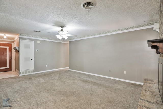 carpeted spare room with a textured ceiling, ceiling fan, and crown molding