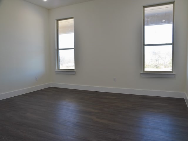 spare room with dark hardwood / wood-style floors