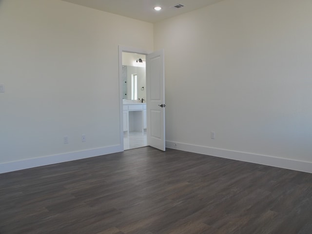 unfurnished room featuring dark wood-type flooring