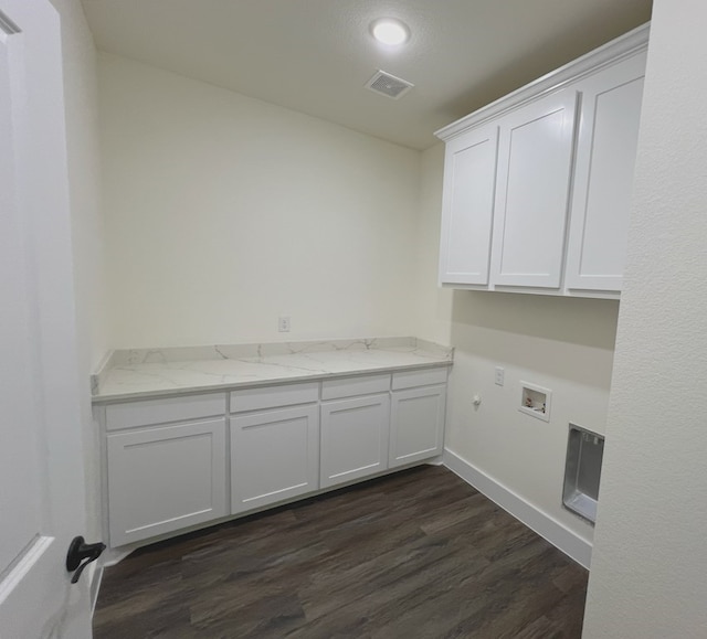 laundry room with hookup for a washing machine, dark hardwood / wood-style flooring, and cabinets