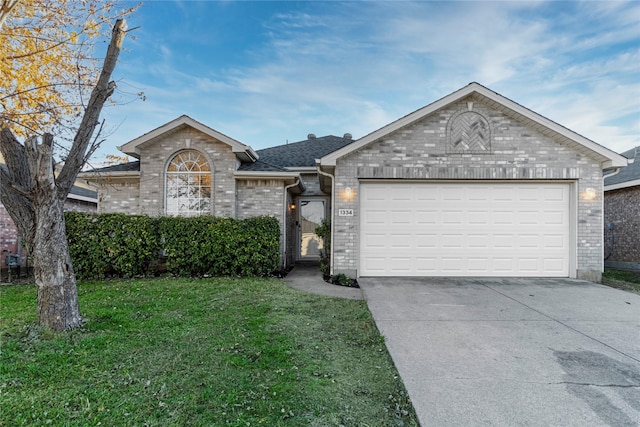 ranch-style house featuring a garage and a front yard