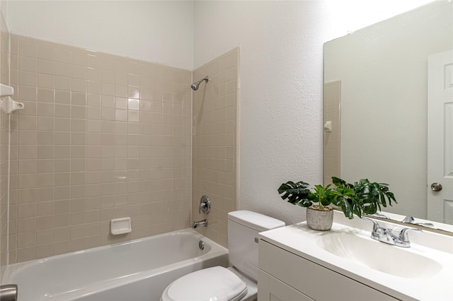 full bathroom featuring tiled shower / bath combo, toilet, and vanity