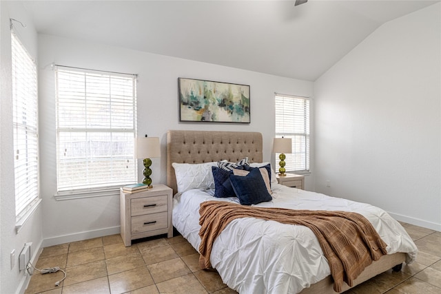 tiled bedroom with multiple windows and vaulted ceiling