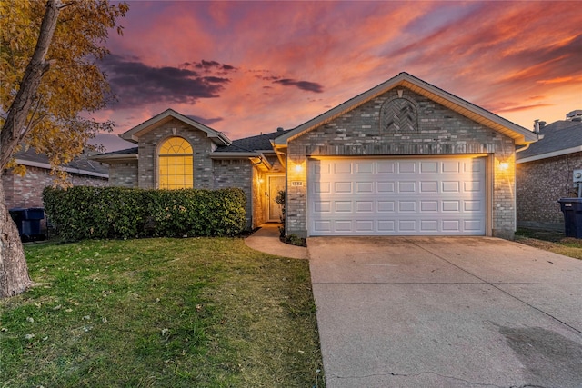 ranch-style home with a lawn and a garage