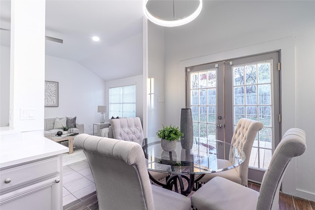 dining room with french doors, plenty of natural light, and lofted ceiling