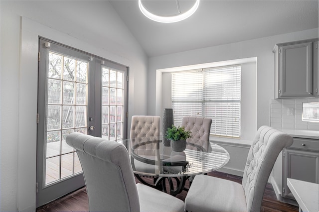 dining space featuring dark hardwood / wood-style flooring and lofted ceiling