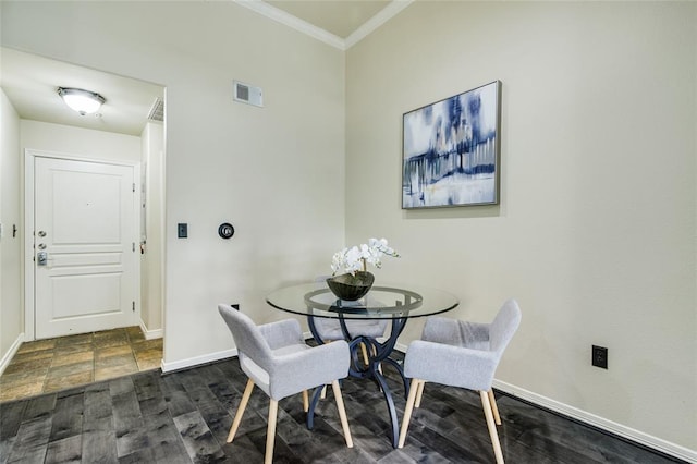 dining room with crown molding and dark hardwood / wood-style floors