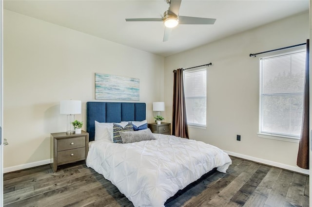 bedroom with dark hardwood / wood-style floors and ceiling fan