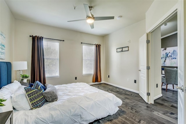 bedroom with ceiling fan and dark hardwood / wood-style floors