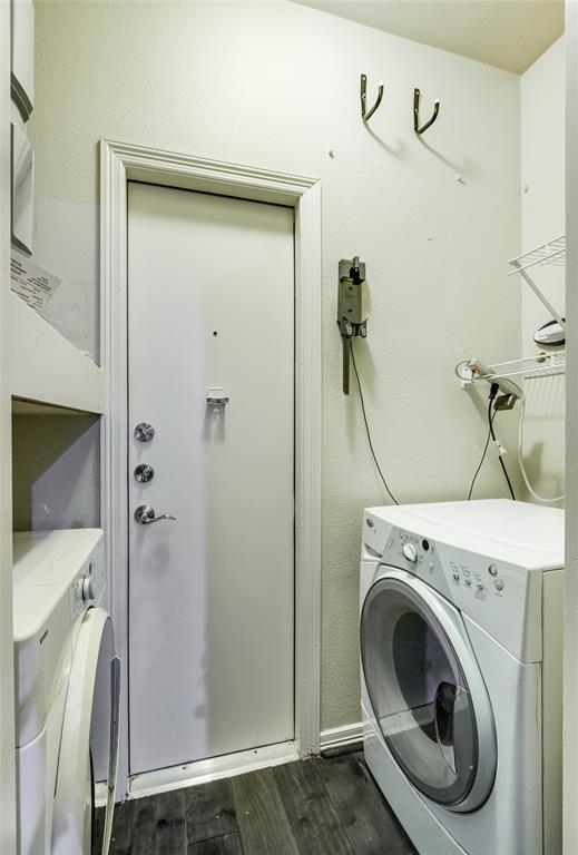 laundry area with dark wood-type flooring