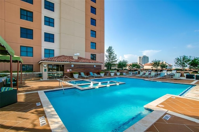 view of pool featuring a community hot tub and a patio