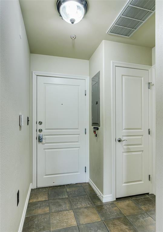 doorway to outside featuring electric panel