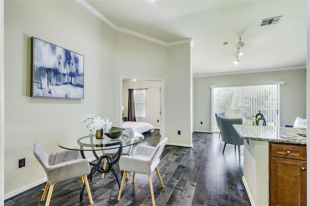 dining space featuring crown molding and dark wood-type flooring