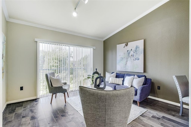 living room featuring ornamental molding, vaulted ceiling, hardwood / wood-style floors, and rail lighting