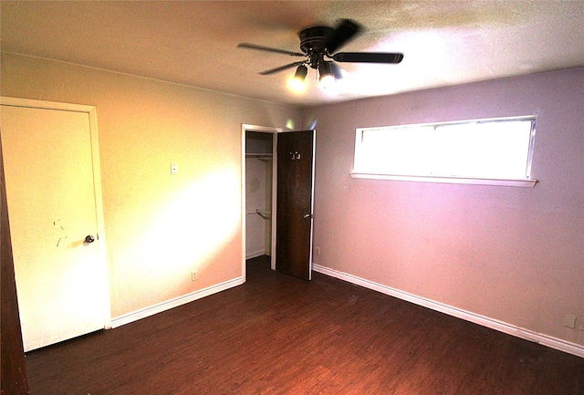 unfurnished bedroom featuring a textured ceiling, dark hardwood / wood-style floors, and ceiling fan