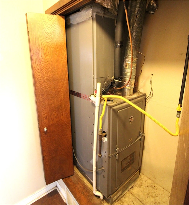 utility room featuring heating unit