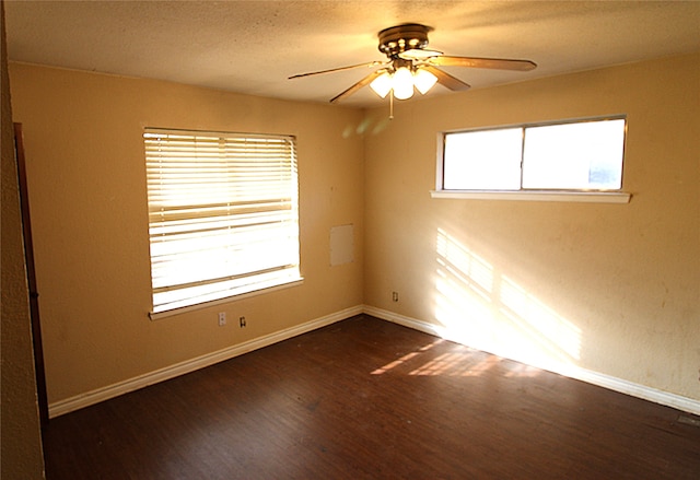 spare room with ceiling fan and dark wood-type flooring