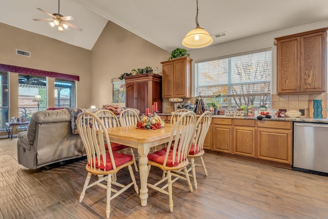 dining area featuring vaulted ceiling, ceiling fan, and light hardwood / wood-style floors