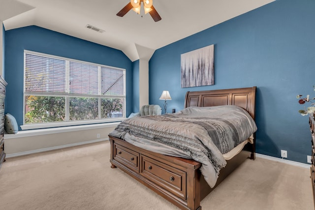 bedroom featuring vaulted ceiling, light colored carpet, and ceiling fan