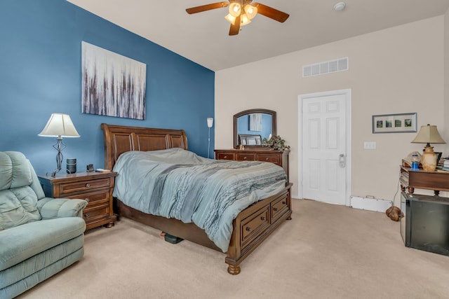 bedroom featuring light carpet and ceiling fan