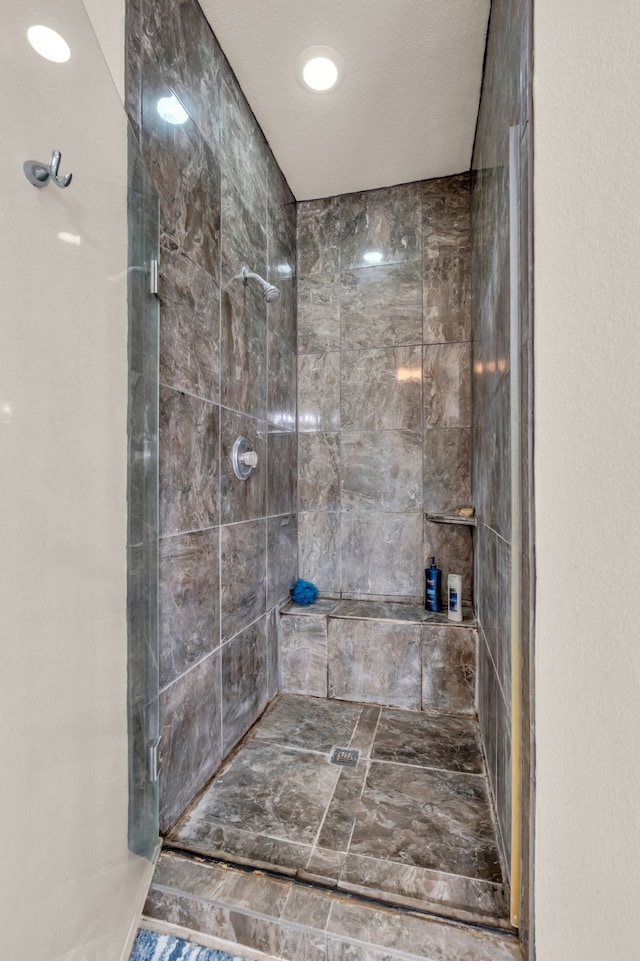 bathroom with a tile shower