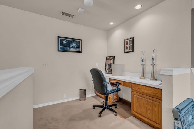 office area with heating unit and light carpet