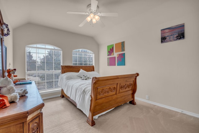 bedroom featuring ceiling fan, light colored carpet, and vaulted ceiling