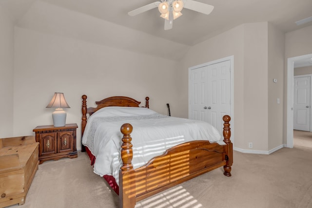 carpeted bedroom featuring vaulted ceiling, ceiling fan, and a closet